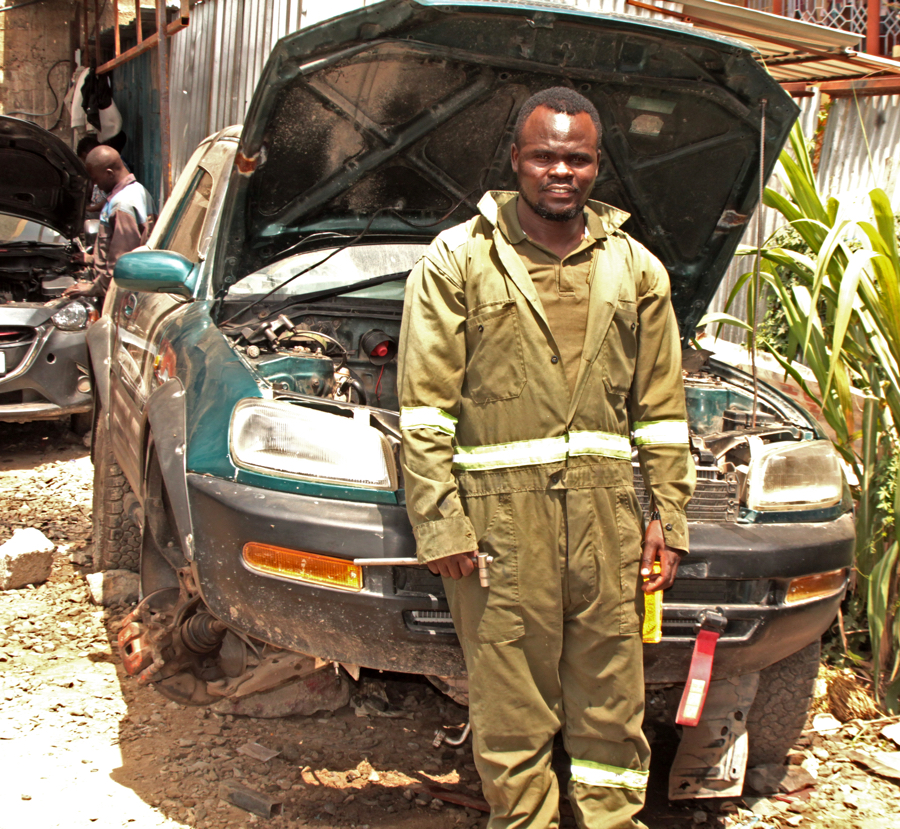 Car mechanic Dalmas in front of a car
