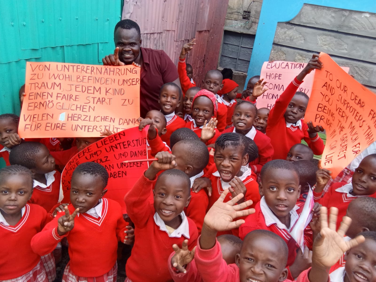 Group of young kids and Dalmas holding placards
